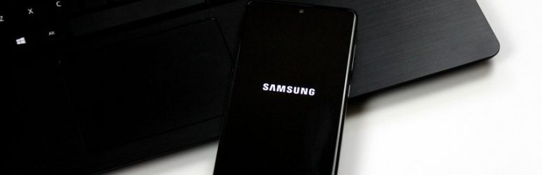 Riga, Latvia - June 17, 2021: Photo of a Samsung Galaxy A71 Android smartphone with android logo on black laptop. Software update on android smartphone